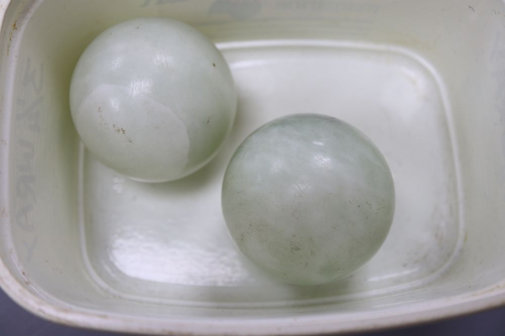 Four Chinese hardstone carvings, one of a gent, a cup and two balls